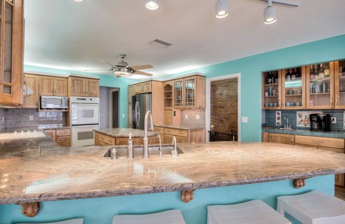 Yacht Club House | Lovely Canal Home in SW Cape with heated pool, game room, and a tiki on the dock