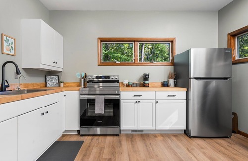 Big Rapids House | Nestled in the woods, this private detached Guest House is a perfect getaway!