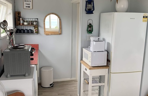 Cape Palliser House | Ocean views of the Kaikoura's and surf break. Private beach hut.