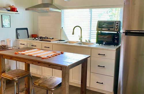 Eustis Cottage | Pine Forest Studio, serene winding lane to cozy retreat.