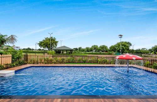 Nashik Villa | SaffronStays Amaltas, Nashik - pool villa with huge lawns perfect for large groups and corporate offsites