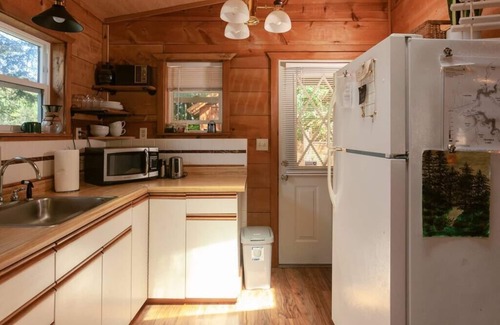 Lakeside Cabin | Secluded 1-bedroom lakefront cabin in Lakeside, OR. Ideal for writers or couples seeking solitude. Features a King bed, wood stove, kayak for 2, and stargazing from your private dock.