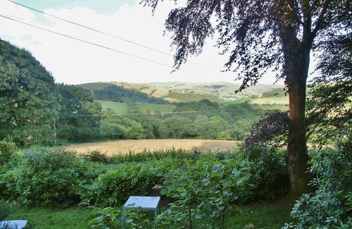 Llanidloes House | Secluded Caravan next to 2 pools & waterfalls. Decking area & Summer house