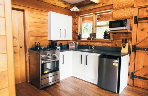 Clutha District House | Secluded Eco-friendly Log Cabin with Steaming Outdoor Baths