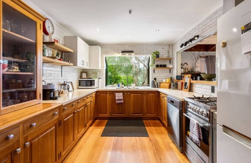 Auckland Region House | Serene Shoreline with Seaview and Kayak