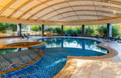 Lonavala Villa | StayVista's Emerald Acres offering a heated pool, bonfire, snooker table, scenic views, tennis court, steam room, gazebo, & gym