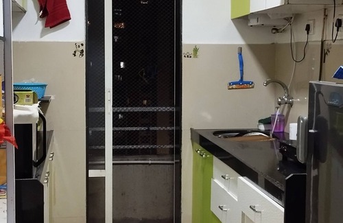 Mira Road East Apartment | The perchnOne cosy room with swimming pool and gym.