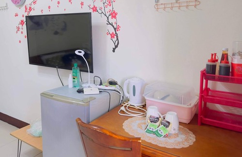 Hukou Apartment | This room have its own private bathroom, bed, cabled tv, wardrobe and balcony.