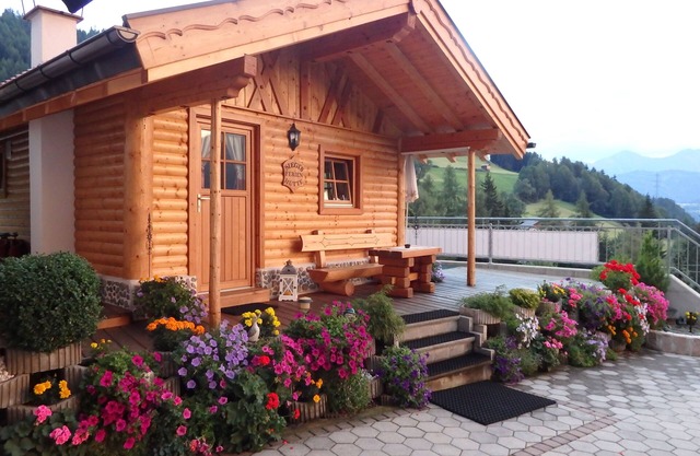 Beautiful wooden hut with a cozy fireplace, stone pine parlor and stone pine bed
