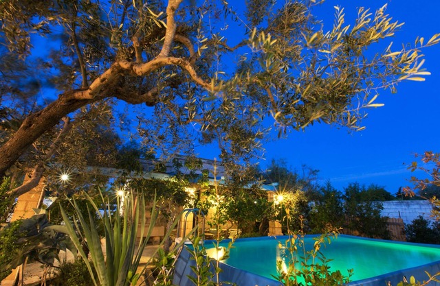 Bright villa with swimming pool surrounded by greenery near the sea