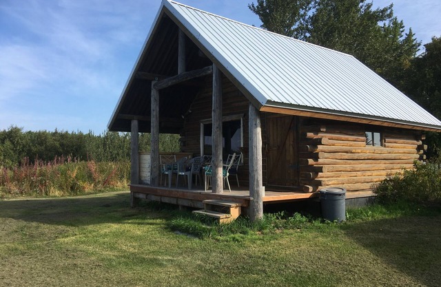 CABIN BY THE BLUFF OF KENAI RIVER WITH MOUNTAIN VIEW