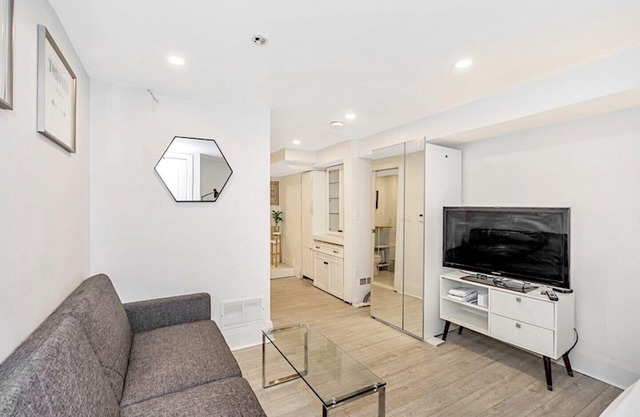 Clean, white, bright and close to Woodbine subway