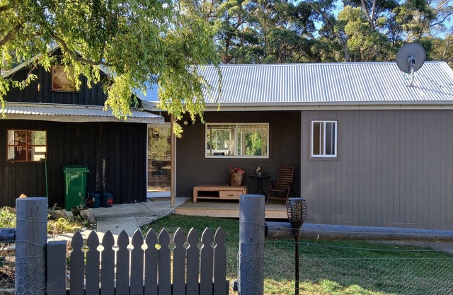 cosy cottage with wood heater, surrounded by bushland