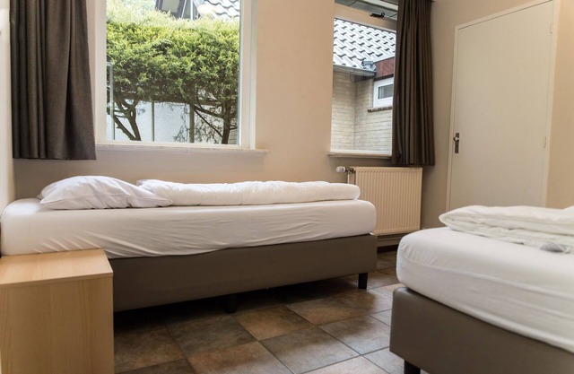 Cozy house with a fireplace in a holiday park in a natural area