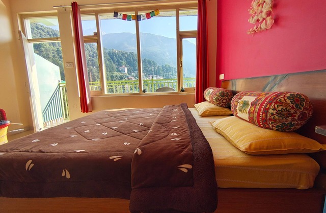 Golden View BnB Mcleodganj nRoom with private balcony facing mountain view.