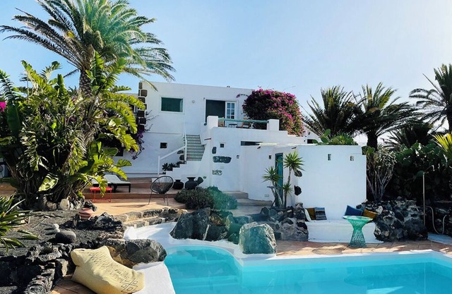 Green oasis with pool and view of the mountains of fire