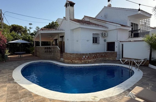 House with swimming pool next to the beach