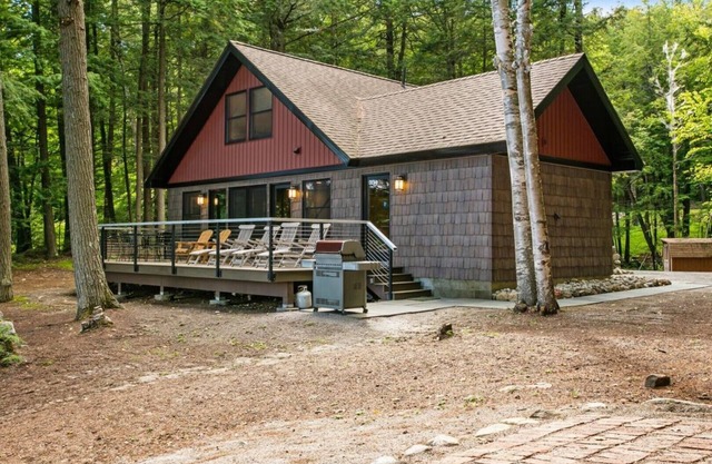 Lakefront home steps away from a private, gentle sloping sandy beach & fire pit.