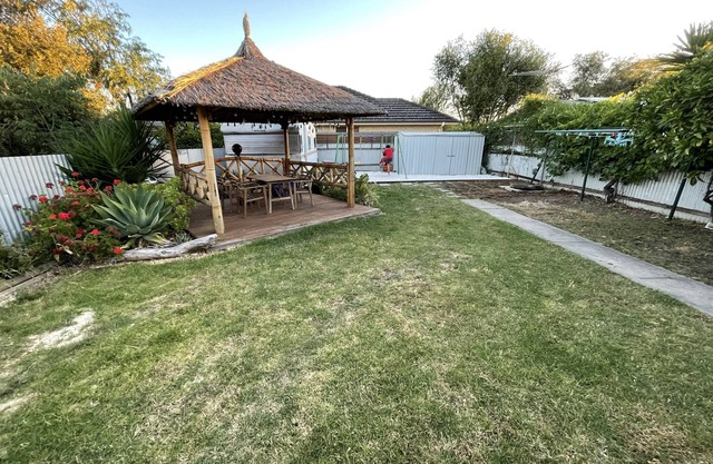 Large backyard with outdoor seating and BBQ!
