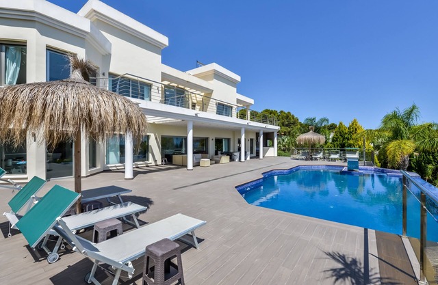Large modern villa with indoor and outdoor pool sauna and bar.