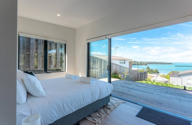 Marama Cottages - Luna Cottage - Located in the heart of Surfdale with outstanding views over the water this brand new 2 bedroom apartment is perfect for family holidays on Waiheke – walking distance to local beaches, off street parking for up to 2 v