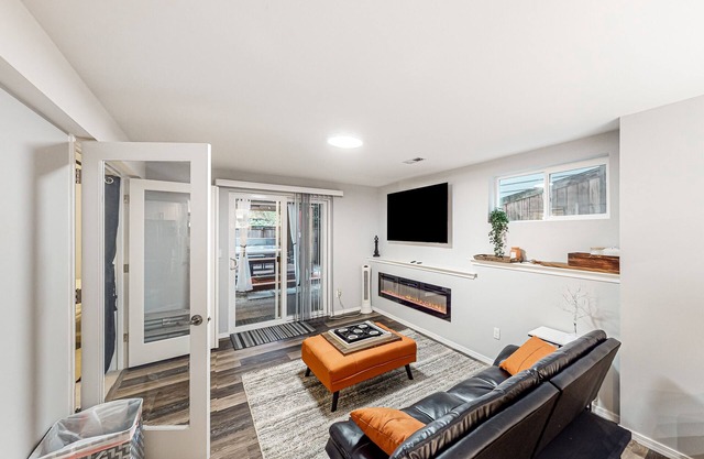 Modern lower-level getaway with a fireplace, inviting patio & washer/dryer