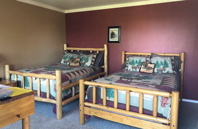 Moose Is Inn Room 2- Two double beds with a balcony view