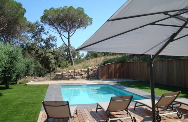 new villa with heated pool under umbrella pines and olive trees.