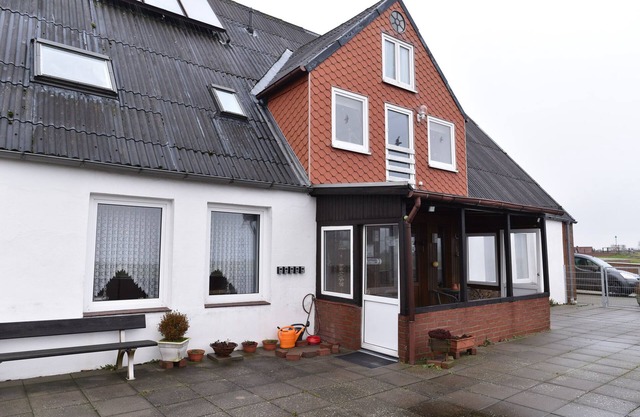Nordseehaus Op'n'Diek on the dike overlooking the small Priel harbor.