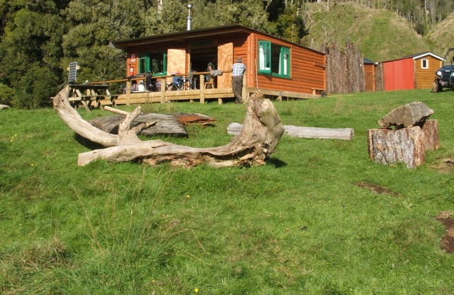 Private log cabin in valley.