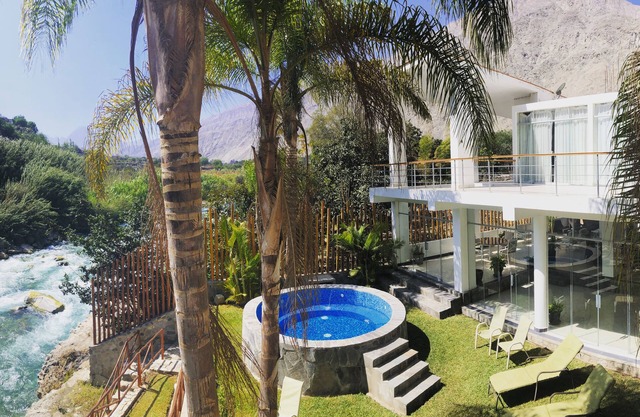 Riverfront house with private pool and garden