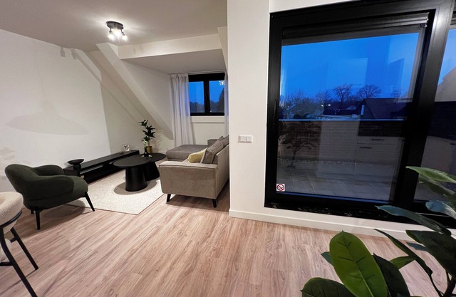 Sleek apartment with parking, fast WiFi, and garden access near cultural spots. Sleeps four.