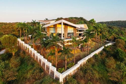 StayVista's Emerald Acres offering a heated pool, bonfire, snooker table, scenic views, tennis court, steam room, gazebo, & gym