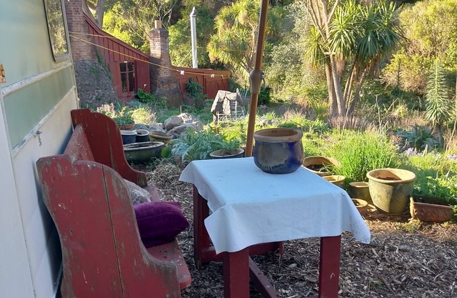 Stylish vintage caravan on a farm over looking bush and river.