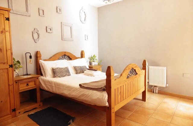 This is a double room with a double bed. It has an en-suite bathroom. The window in the room looks out into the hallway.