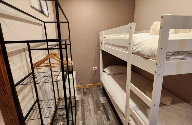 This room is a bunk room with two single bunk beds. The bathroom and showers are shared with the two other bunk rooms . The room has a great view of the village square.