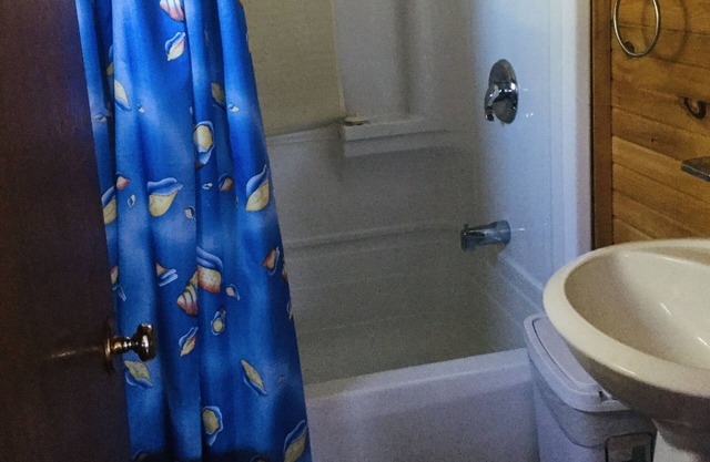 Two Bedroom Cottage With Open Concept Leading To Large Patio And Screened Porch.