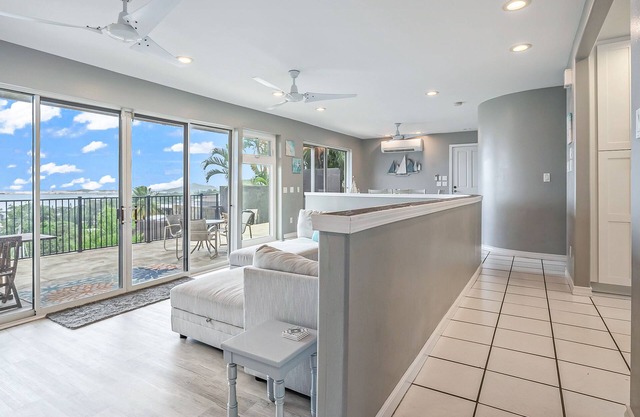 Two-story ocean view home with a furnished patio & deck, washer/dryer, & AC