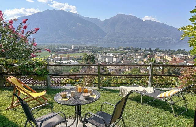 Vacation apartment with panoramic view and outdoor pool, garden seating area and sunbathing lawn